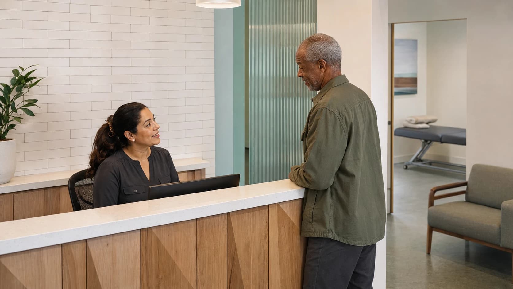 A patient checking in at a physical therapy clinic front desk